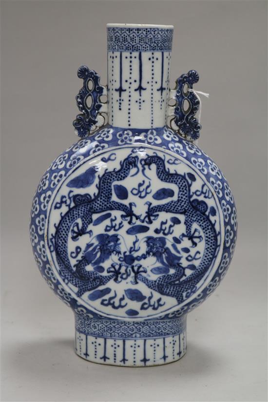 A Chinese blue and white moon flask decorated with dragons